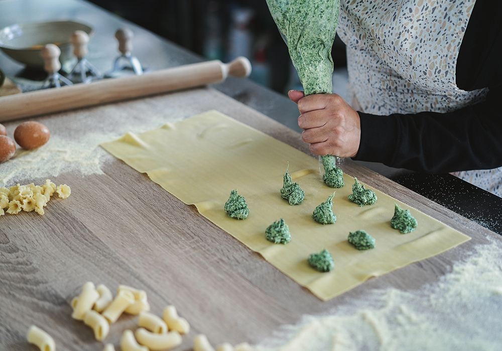 Chef preparing fresh handmade ravioli in a pasta laboratory